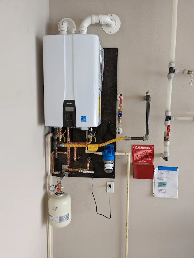 Professional plumber installing copper piping in a Chester home